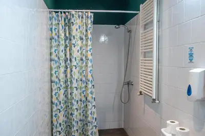a bathroom with a shower with a shower curtain at Inout in Barcelona