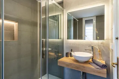 a bathroom with a sink and a glass shower at Canela Homes COSTA CASA AILA in Castelldefels