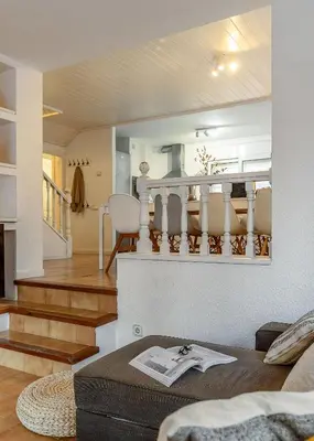 a living room with a couch and a staircase at Canela Homes COSTA CASA AILA in Castelldefels