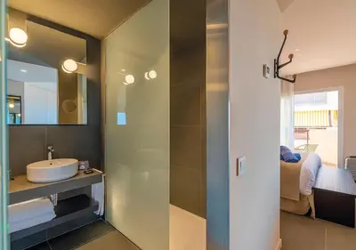 a bathroom with a sink and a mirror at AQUA Hotel Promenade & Spa 4Sup in Pineda de Mar