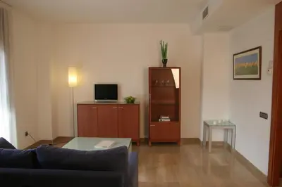 a living room with a couch and a television at Apartaments Aragó565 in Barcelona