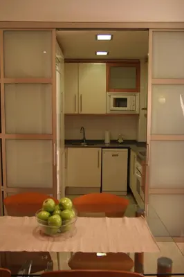 a kitchen with a bowl of apples on a table at Apartaments Aragó565 in Barcelona