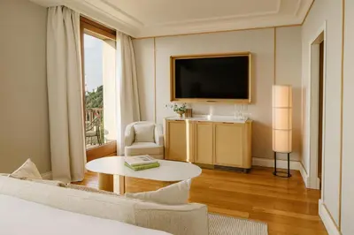 a hotel room with a bed and a tv and a table at METT Barcelona GL - A Leading Hotel of the World in Barcelona
