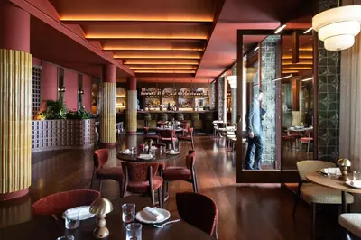 a restaurant with tables and chairs and a bar at METT Barcelona GL - A Leading Hotel of the World in Barcelona