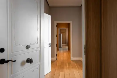 a hallway with a white door and a wooden floor at METT Barcelona GL - A Leading Hotel of the World in Barcelona