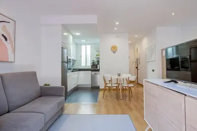a living room and kitchen with a couch and a table at Feelathome Center Apartments in Barcelona