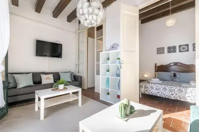a living room with a couch and a table at Vistamar 2: Primera línea de mar con gran terraza in Sitges