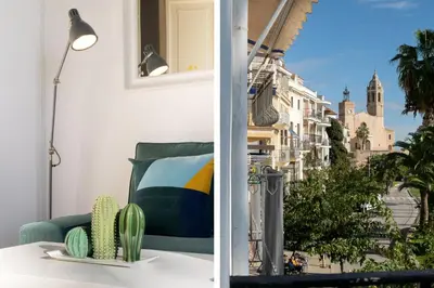 a living room with a table and a view of a city at Vistamar 2: Primera línea de mar con gran terraza in Sitges