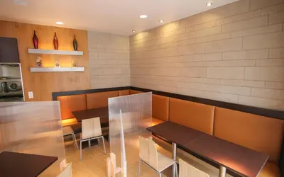 a dining room with two tables and chairs at Hotel Esplugues in Esplugues de Llobregat