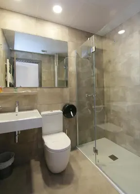 a bathroom with a toilet and a sink and a shower at Hotel Esplugues in Esplugues de Llobregat