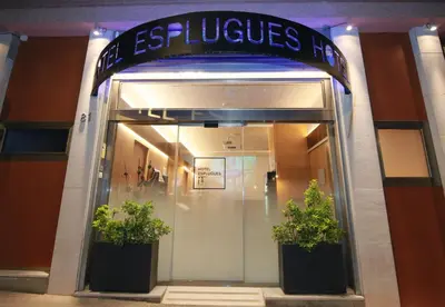 a store front with two potted plants in front of it at Hotel Esplugues in Esplugues de Llobregat