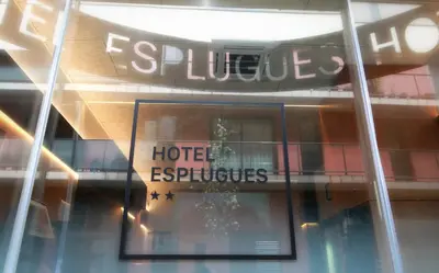 a reflection of a hotel sign in a window at Hotel Esplugues in Esplugues de Llobregat