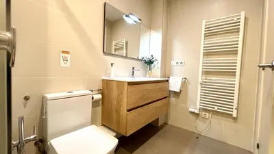 a bathroom with a toilet and a sink and a shower at Suites4days Provenza Apartment in Barcelona