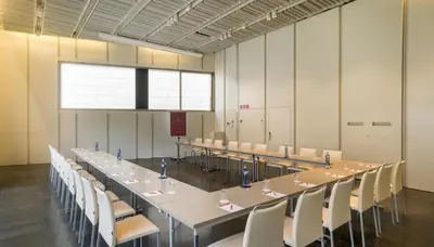 a large conference room with a long table and chairs at NH Collection Barcelona Constanza in Barcelona