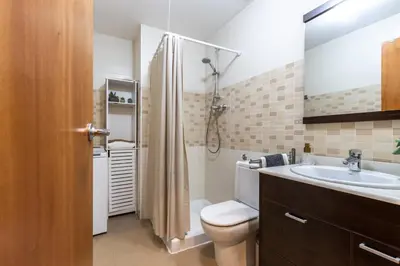 a bathroom with a toilet and a sink and a mirror at Fantástico loft cerca centro by Lofties in Terrassa