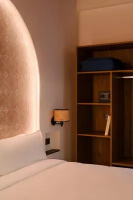 a bedroom with a bed and a book shelf at Hotel Hamsa House in Barcelona
