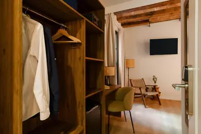 a room with a closet with a desk and a chair at Hotel Hamsa House in Barcelona