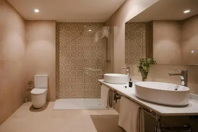 a bathroom with two sinks and a toilet at Hotel Hamsa House in Barcelona