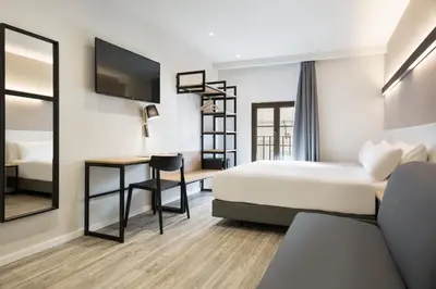 a hotel room with a bed and a desk at Acta BCN 40 in Barcelona