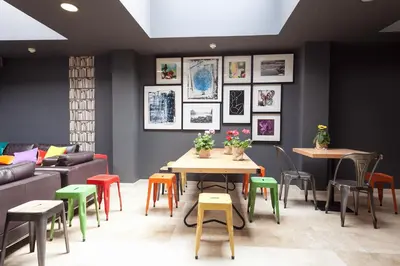 a room with tables and chairs and a couch at Acta BCN 40 in Barcelona