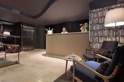 a woman standing at the counter of a hair salon at Acta BCN 40 in Barcelona