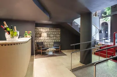 a lobby with a staircase and a table and chairs at Acta BCN 40 in Barcelona