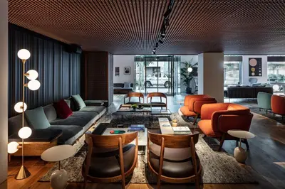 a lobby with chairs and tables in a room at Sir Victor Hotel, part of Sircle Collection in Barcelona