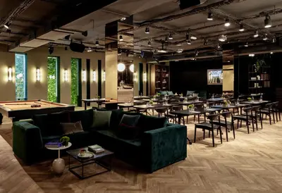 a large room with tables and couches and a room with tables and chairs at Sir Victor Hotel, part of Sircle Collection in Barcelona