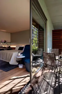 a bedroom with a bed and a table and chairs at Sir Victor Hotel, part of Sircle Collection in Barcelona