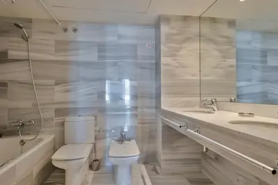 a white bathroom with a toilet and a sink at Alcam Llum Deluxe in Barcelona