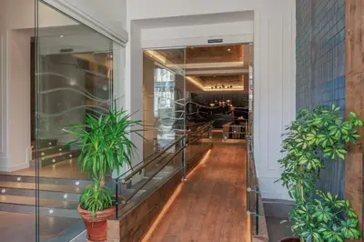 a hallway with two potted plants in a building at Hotel Medinaceli 4 Estrellas SUPERIOR in Barcelona