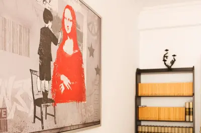 a painting on a wall in a living room at ApartEasy - Private Terrace, 3-Bedroom Apartment in Barcelona