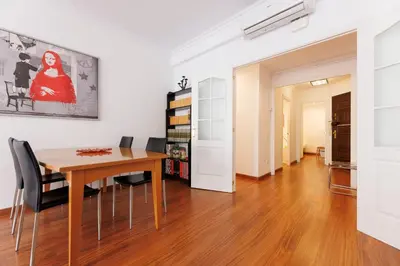 a dining room with a table and chairs at ApartEasy - Private Terrace, 3-Bedroom Apartment in Barcelona