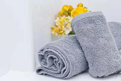 a pair of towels sitting on a bathroom counter at Barcelona City North Hostal in Barcelona