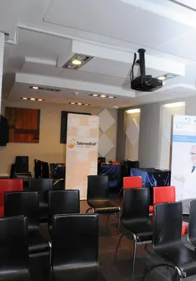 a conference room with chairs and a presentation at Llagotel in La Llagosta