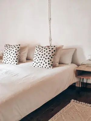 a bed with pillows on it in a room at Casa Om in Dosríus