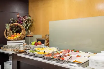 a buffet with many different types of food on a table at Hotel Madanis in Barcelona
