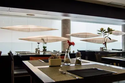 a dining room with a table and chairs and lights at Hotel Madanis in Barcelona
