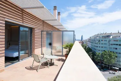 a balcony with a table and chairs on a building at Hotel Sant Pau in Barcelona