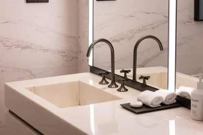 a bathroom sink with two faucets and a mirror at Hotel Miramar Barcelona GL - Preferred Hotels & Resorts - Newly Renovated in Barcelona