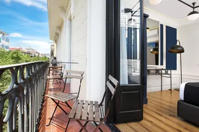 a balcony with two chairs and a glass door at Hotel Market in Barcelona