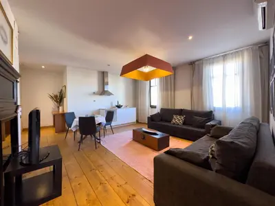 a living room with a couch and a dining room at Hotel Market in Barcelona