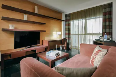 a living room with a couch and a flat screen tv at Hesperia Fira in Hospitalet de Llobregat