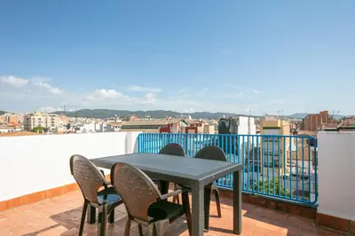 a table and chairs on a balcony with a view at Alcam Badalona Roger in Badalona