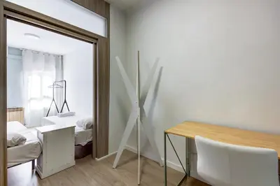 a room with a mirror and a table and a bed at Barcelona Beach Vibes in Sant Adria de Besos
