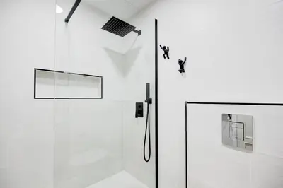 a bathroom with a shower and a glass door at Barcelona Beach Vibes in Sant Adria de Besos