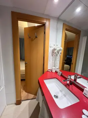 a bathroom with a red counter and a sink at Platjador in Sitges