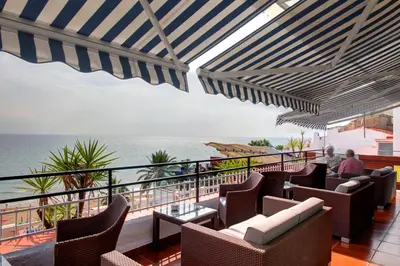 a balcony with chairs and a view of the ocean at Platjador in Sitges