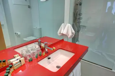 a bathroom with a red sink and a shower at Platjador in Sitges
