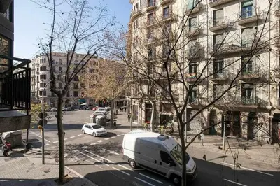 a white van parked on a city street with buildings at Consell Cent apartment I 3 dormitorios Eixample in Barcelona